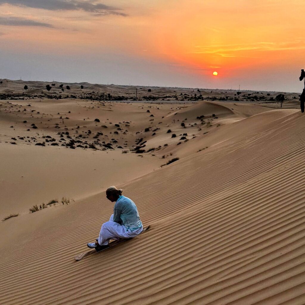 sand boarding abu dhabi desert goldern hour