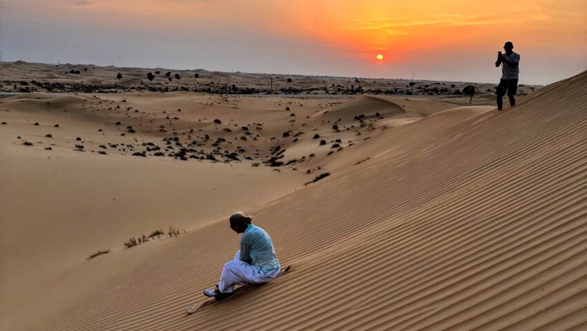 sand boarding abu dhabi desert goldern hour